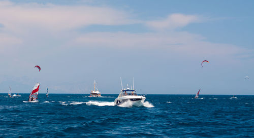 Boats sailing in sea against sky