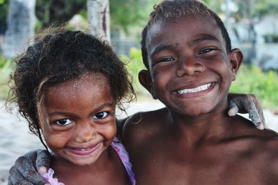 Portrait of happy siblings outdoors