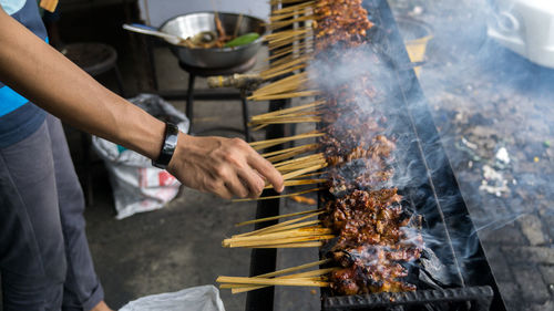 Midsection of man preparing food