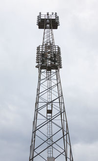 Low angle view of communications tower against sky