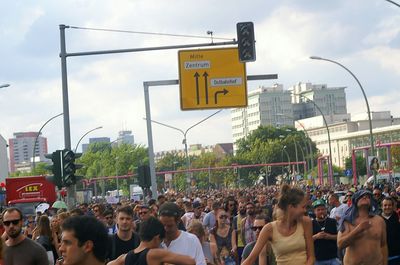 Rear view of people standing on city street