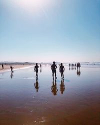 People on beach against sky