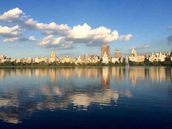 Calm river with buildings in background