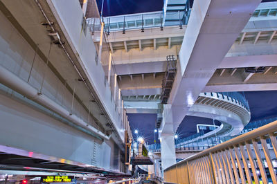 Low angle view of bridge amidst buildings in city