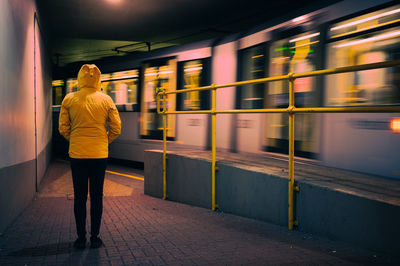 Rear view of man walking in subway
