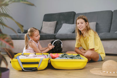 Portrait of smiling friends sitting at home