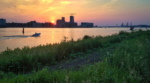 Scenic view of river against sky during sunset