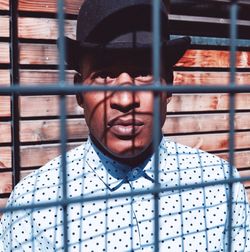 Portrait of man through fence