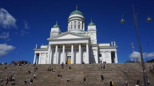 Group of people in front of building against sky