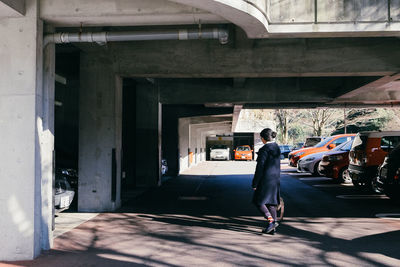 Full length of woman walking at parking lot