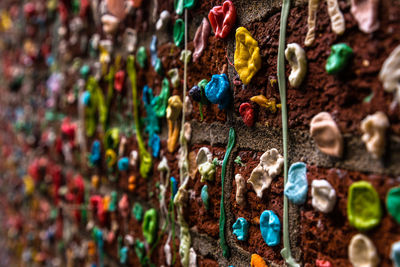 Close-up of bubble gums stuck on brick wall