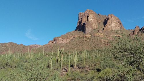 Scenic view of mountains against clear blue sky