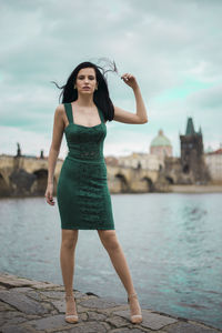 Portrait of young woman standing in water