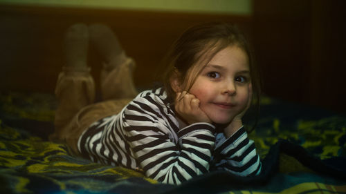 Portrait of girl relaxing on bed at home