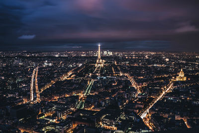 Aerial view of city lit up at night