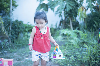 Portrait of cute girl standing on field