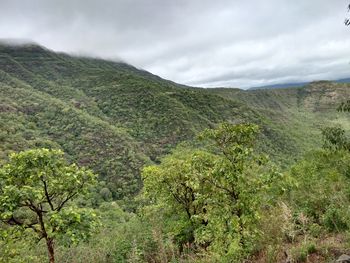 Scenic view of mountains against cloudy sky