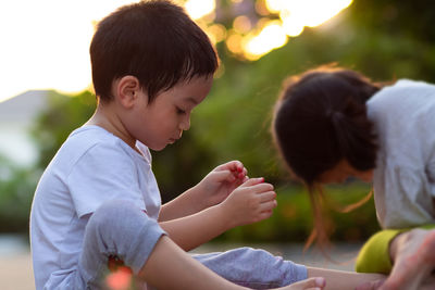 Rear view of friends sitting outdoors