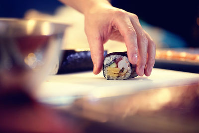 Cropped image of chef preparing sushi in restaurant