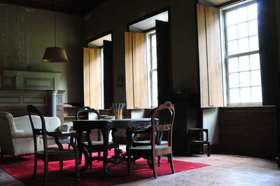 Empty chairs and table in room