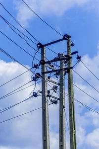 Low angle view of electricity pylon against sky