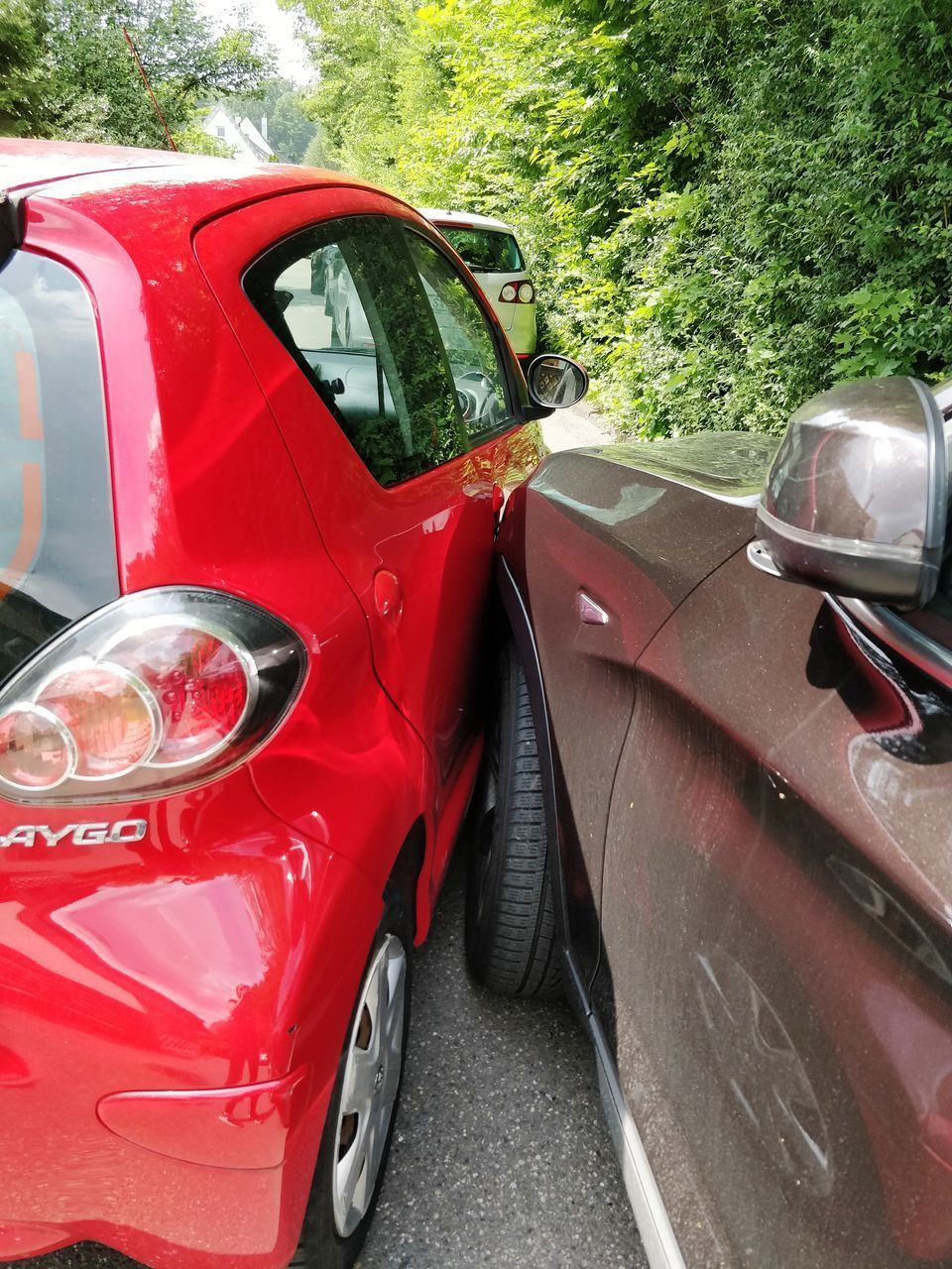 CLOSE-UP OF RED CAR ON MIRROR