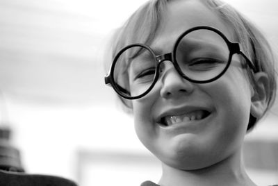 Close-up of crying little boy wearing eyeglasses