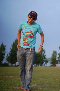 Portrait of young man standing on field
