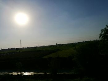 Scenic view of silhouette field against sky at sunset