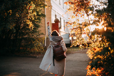 Rear view of woman standing in park