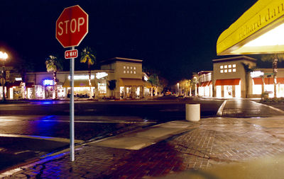 Illuminated road sign at night