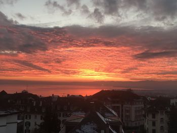 High angle view of townscape against orange sky