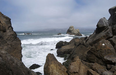 Panoramic view of sea and rocks against sky