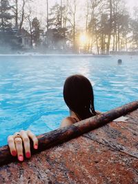 Rear view of woman on swimming pool