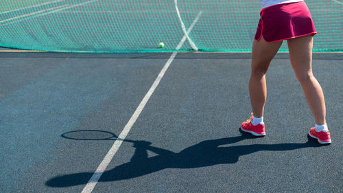 Low section of man playing tennis