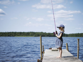 Girl fishing on jetty