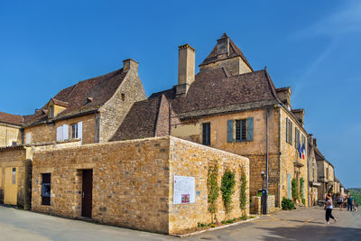 Street with historical houses in domme commune in the dordogne department, france