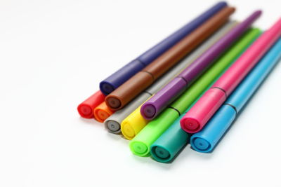 High angle view of multi colored pencils on white background