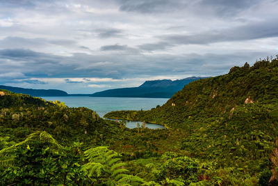 Scenic view of lake and mountains against sky