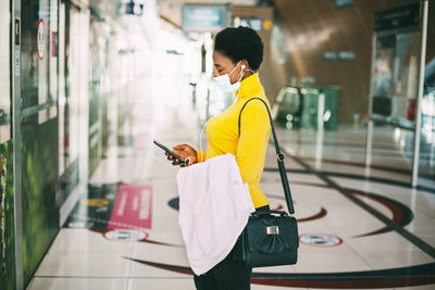 Side view of man using mobile phone