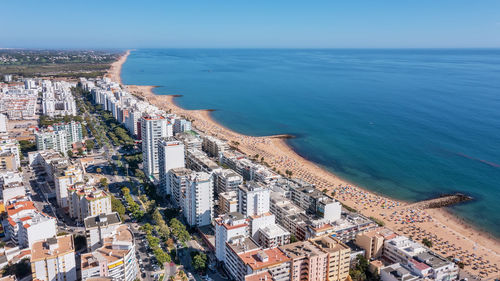 High angle view of sea and buildings against sky