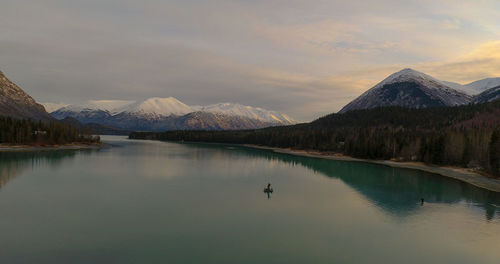 Scenic view of lake and mountains against sky