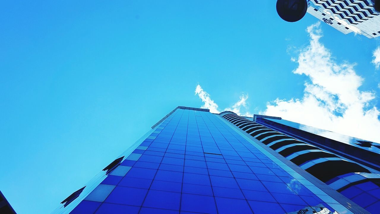 LOW ANGLE VIEW OF BUILDING AGAINST BLUE SKY