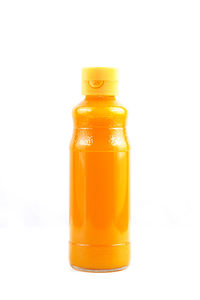 Close-up of yellow bottle against white background