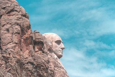 Low angle view of statue against rock formation