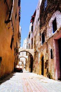 Narrow alley amidst buildings against sky