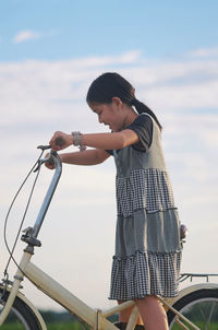 Side view of woman riding bicycle