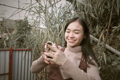 Portrait of young woman holding flower