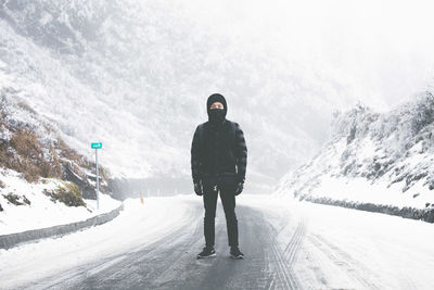 Woman standing on snow covered landscape