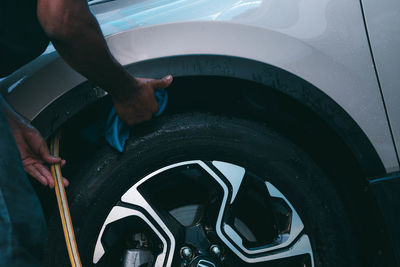 Cropped image of man washing car